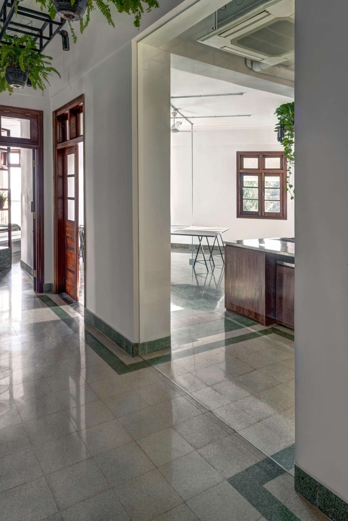 Existent terrazzo flooring guiding through space - the absence of wall vs presence of glass