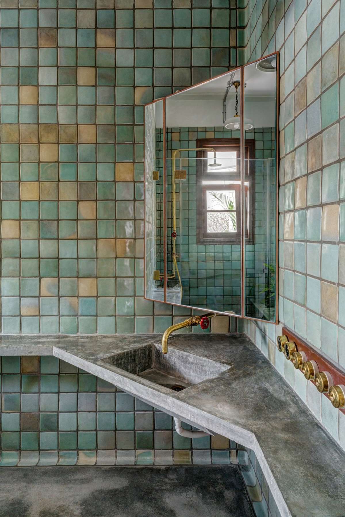 Guest Bathroom - Handmade curved tiles laid in place with brass-ware and concrete counter-top.