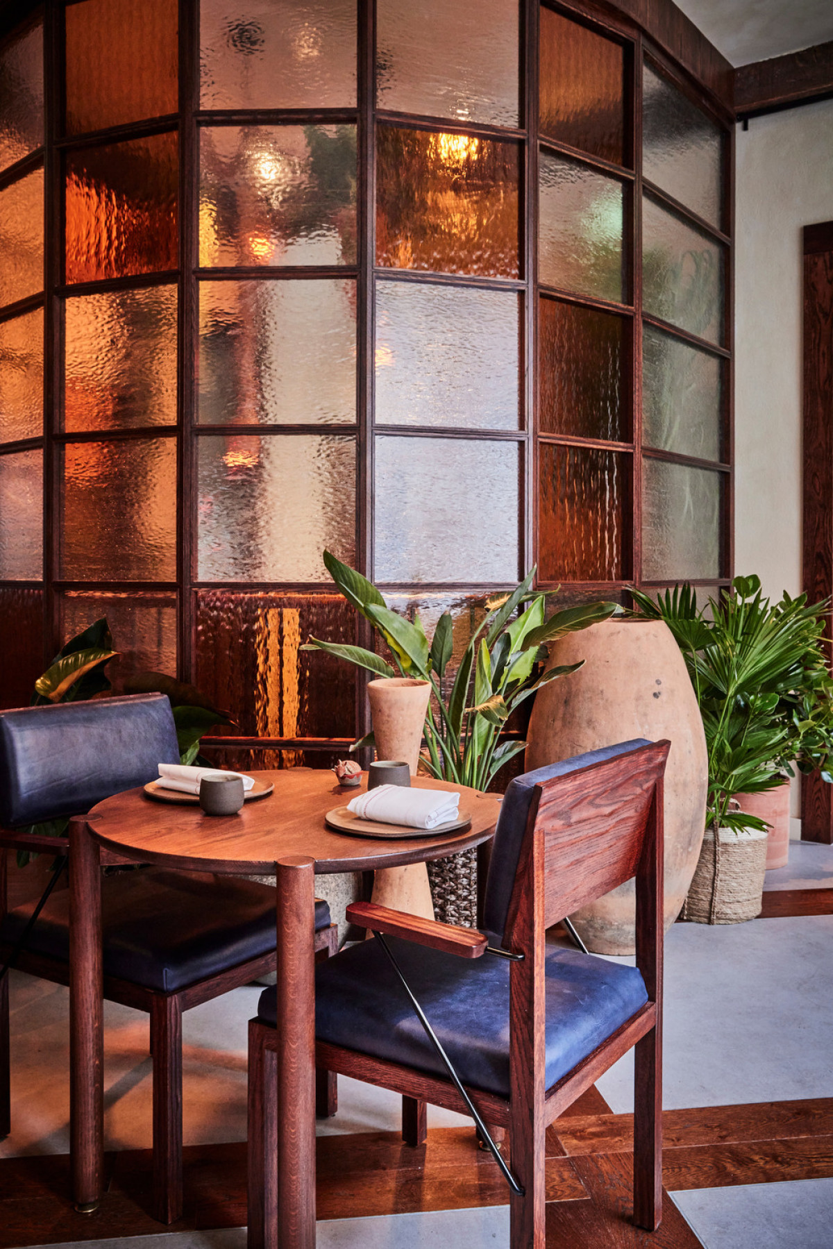 Kol dining room - detail of bespoke table and chairs against the glazed drum | Photo credit: Charlie Mckay