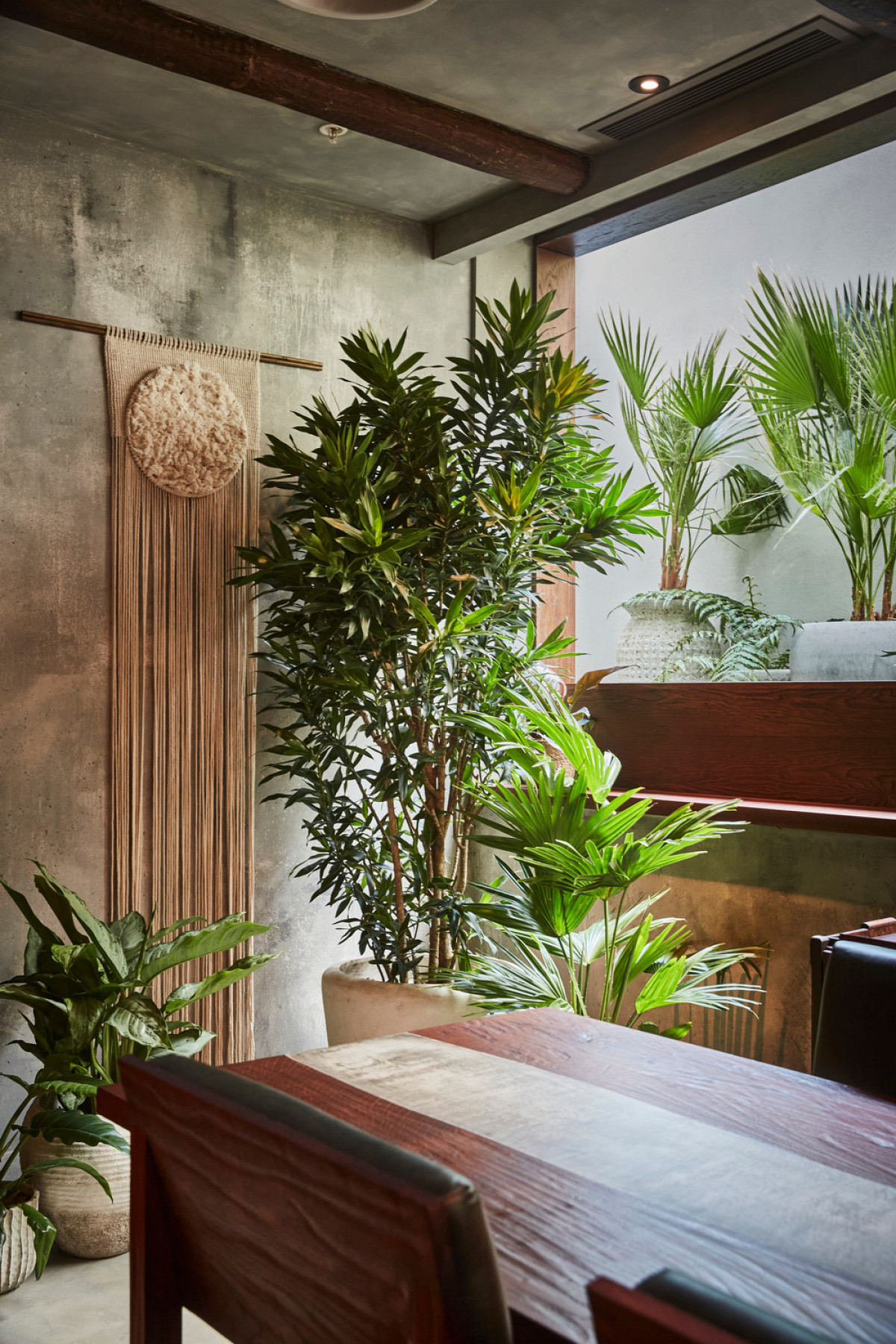 Chef's table dining room - corner detail with view into greenery patio | Photo credit: Charlie Mckay