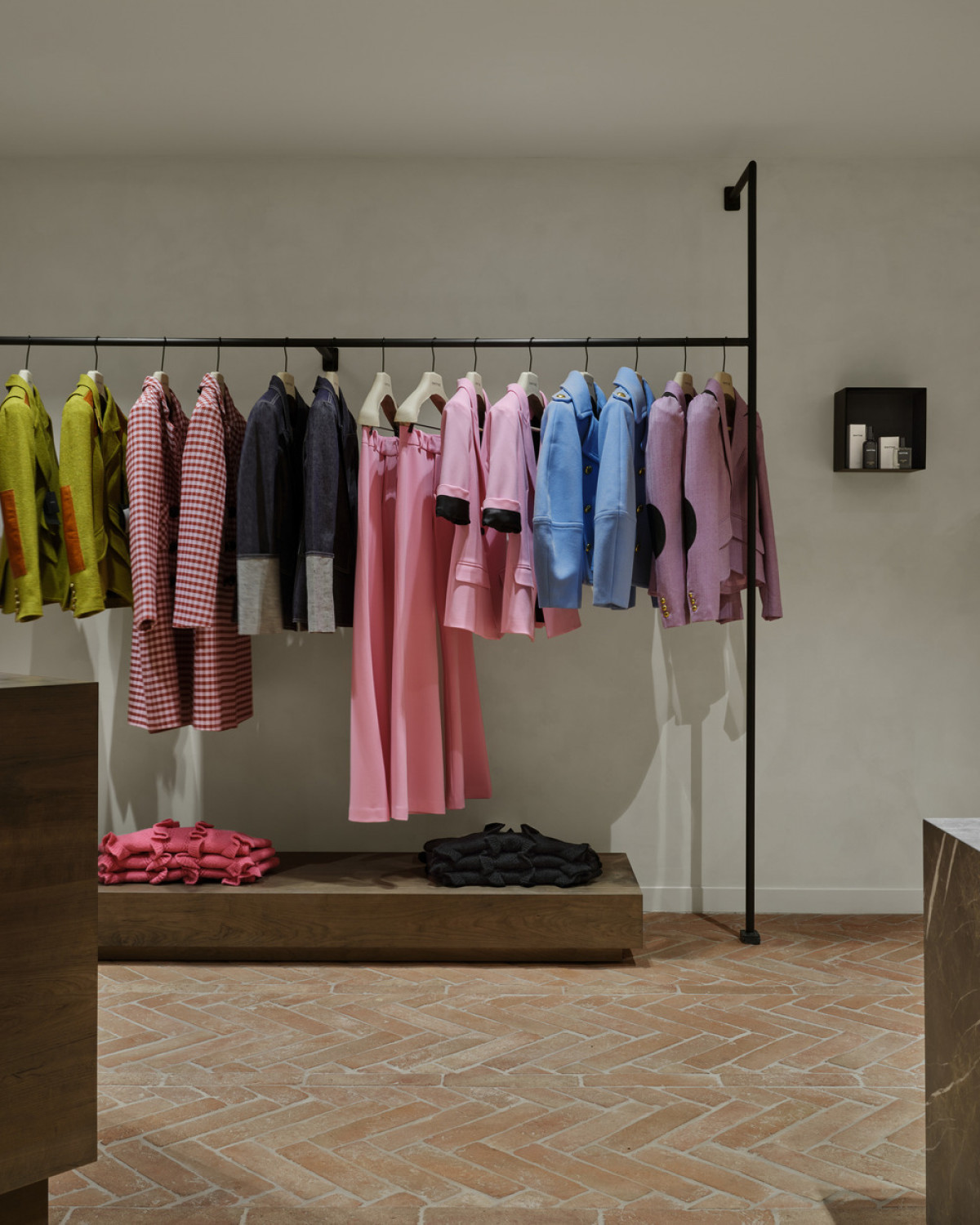 The interior's understated mood allows the fashion label's preference for brilliant colours to stand out.