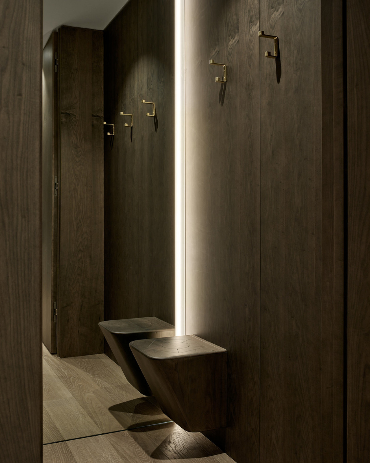 A curved floating stool in the change room is mounted to one wall.