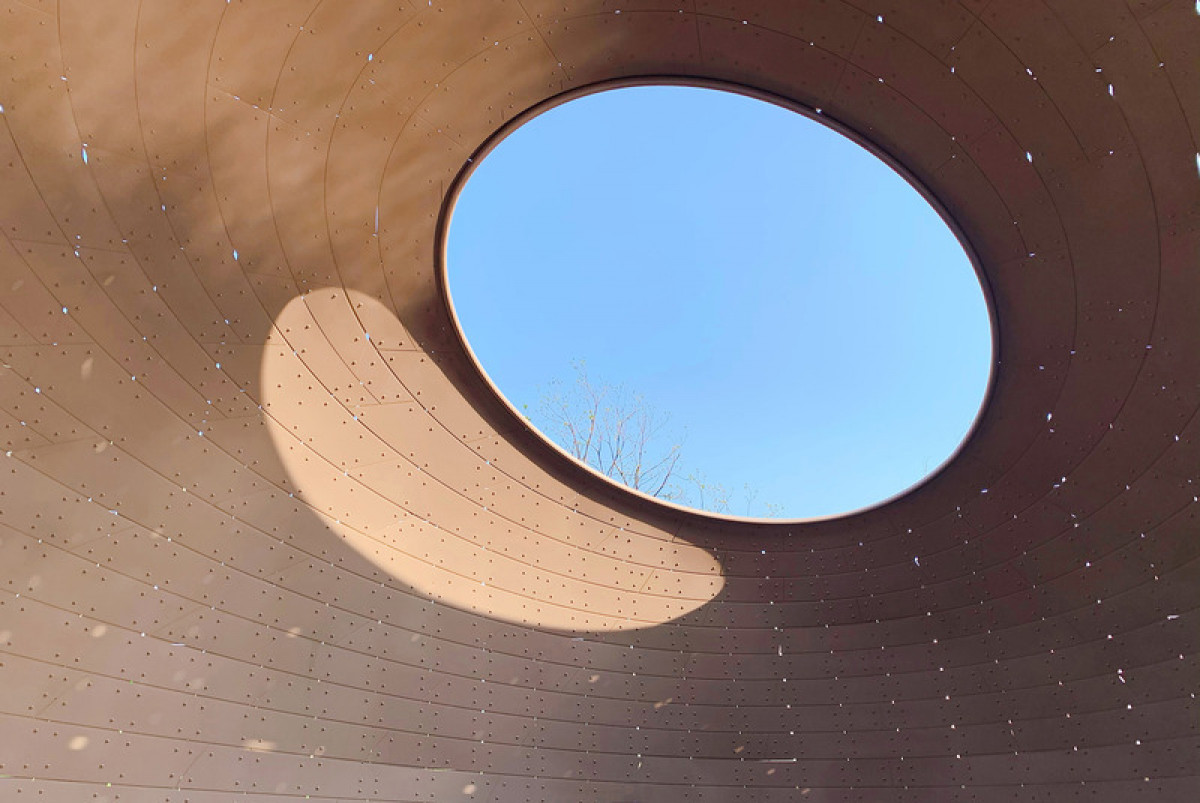 Sunlight and shifting clouds create a dynamic play of light and shadow through the skylight, adding a temporal dimension to the space. Photo credit: Photo by Jia Liu